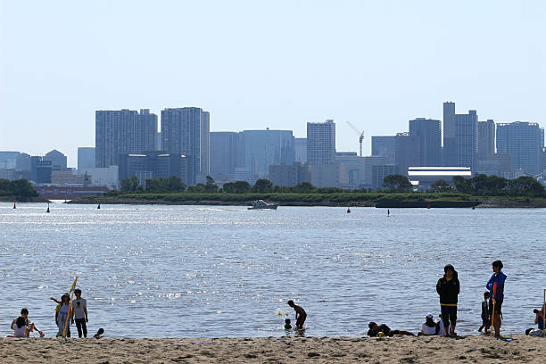 May 5, 2018, Minato Ward, Tokyo, Japan\nPeople enjoying leisure activities on the artificial sandy beach at Odaiba Seaside Park, which offers a panoramic view of Tokyo