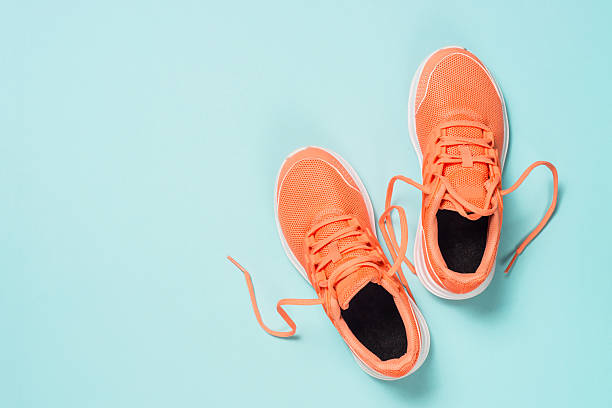 istock Pink sneakers at blue background top view. 2227763920
