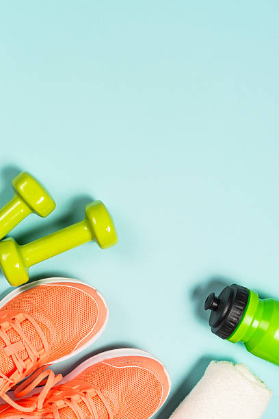 istock Fitness equipment at blue background top view. 2227763948
