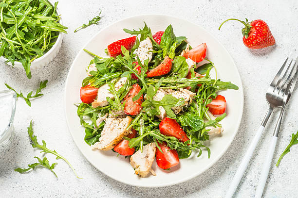 istock Green salad with chicken, strawberry and arugula. 2227764691