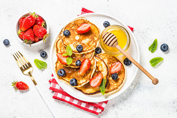 istock Pancakes with fresh berries and honey. 2227764705