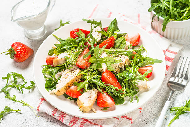 istock Green salad with chicken, strawberry and arugula. 2227764706