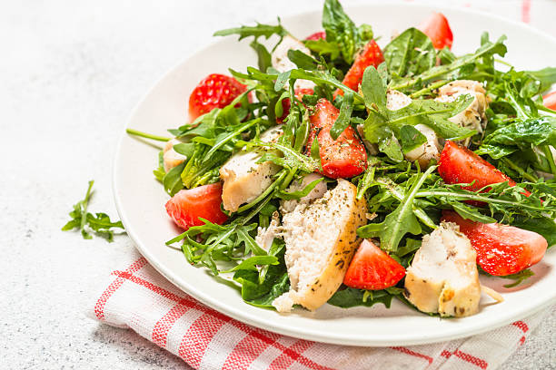 istock Green salad with chicken, strawberry and arugula. 2227764708