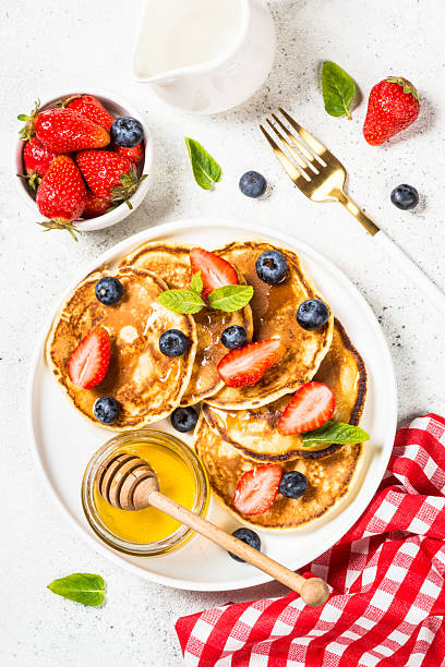Pancakes with fresh berries and honey.