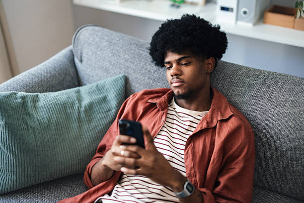 istock Teenager Relaxing at Home While Browsing on a Smartphone 2227767629