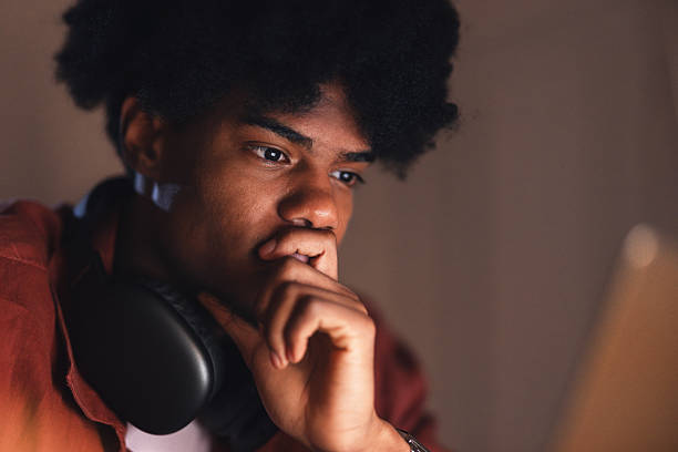 Focused Teenager Studying on Laptop at Home in a Comfortable Setting