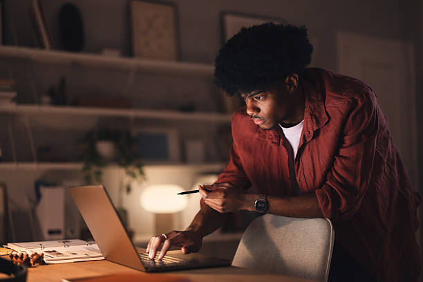 istock Focused Student Studying Intently on Laptop in a Cozy Home Study Space 2227767651
