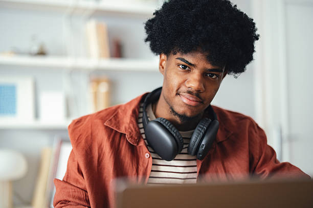 istock Young Man Working with Headphones in a Cozy Home Environment 2227767717