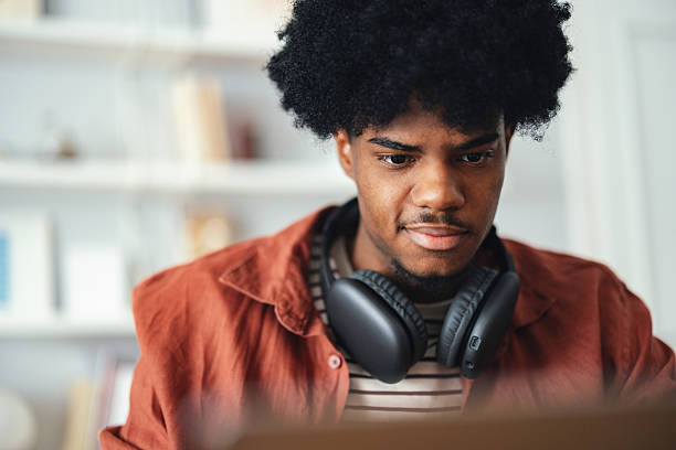 istock Young Student Studying at Home With Headphones in a Bright Room 2227767727