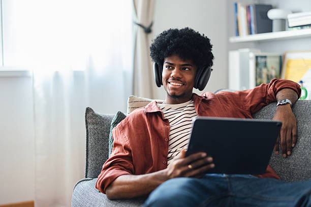 istock Teen Relaxing With Headphones At Home Using A Tablet Device 2227767758