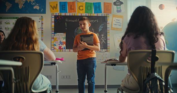 istock Female Teacher Calling Young Student to Board During Science Lesson in Modern Classroom 2227769903