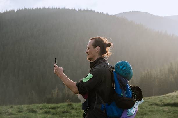 istock Hiker Captures Scenic Mountain View with Smartphone 2227771516