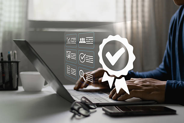 istock ISO Certification, Quality Assurance Process in Digital Business Environment. Person using laptop, document verification, compliance management, standards, performance evaluation, regulatory control. 2227774675