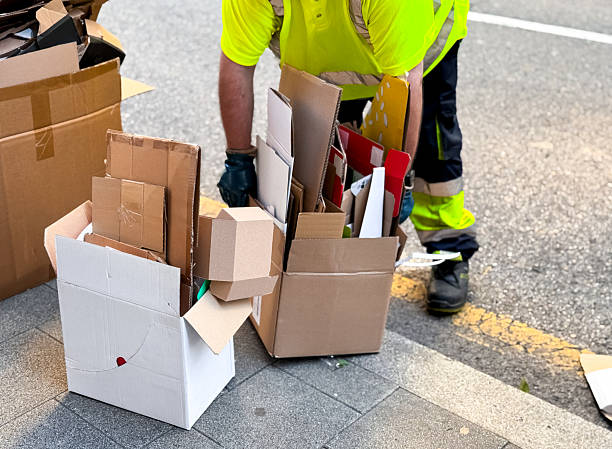istock Worker collecting cardboard boxes for recycling on street 2227774892