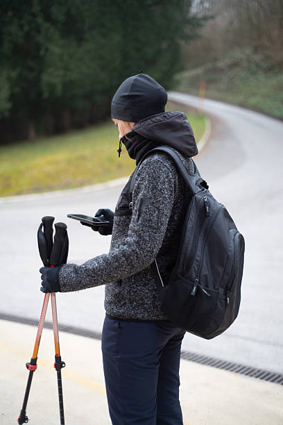 istock Woman checking the walking trail map on her mobile phone 2227778016
