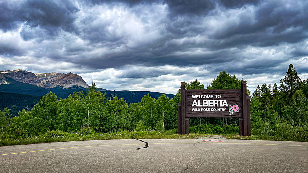 on June 27, 2025 this is the sign at the entrance to Alberta Canada with a view of the majestic mountains in the background