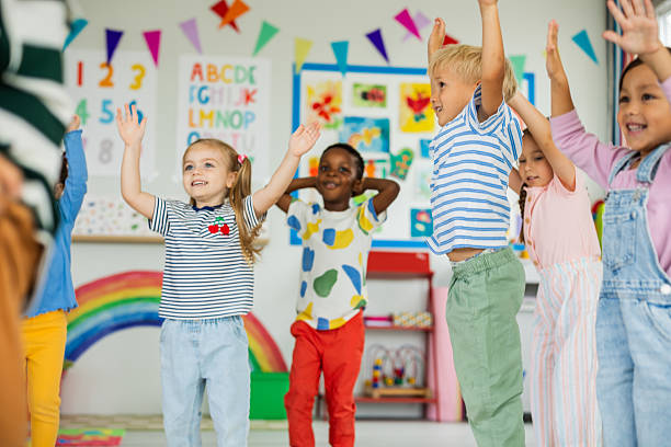 istock Kids in kindergarten doing exercises with their teacher 2227781149