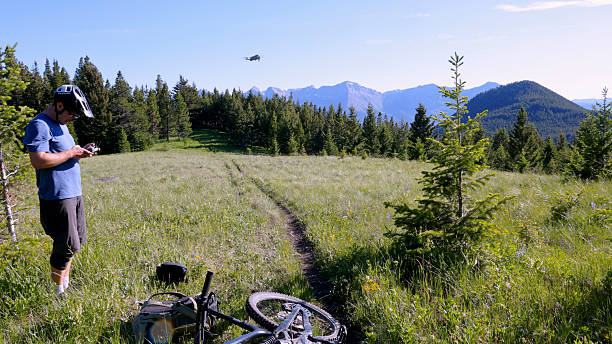 istock Young man flies drone on mountain meadow 2227783488