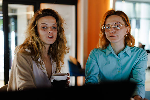 istock Businesswomen collaborate on a project in a modern office setting, discussing ideas and strategies while enjoying coffee during a productive work session 2227783841
