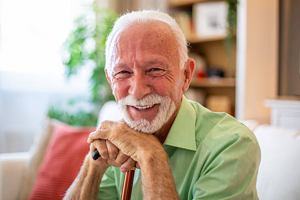istock Happy senior man smiling at home with walking stick 2227784647