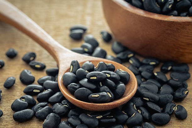 istock Black bean on wooden spoon 2227784780