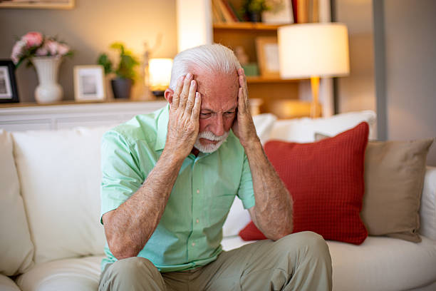 istock Senior man suffering from depression sitting on sofa at home 2227784853