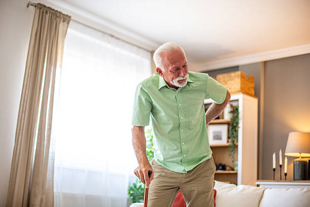 istock Senior man suffering from back pain while standing at home 2227784926