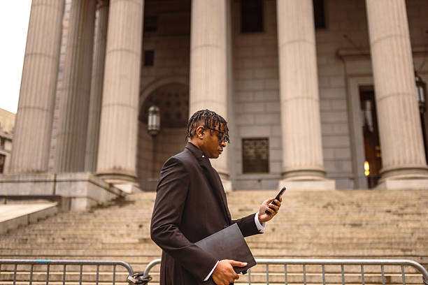 istock Businessman Checking Phone in Front of Courthouse 2227785020
