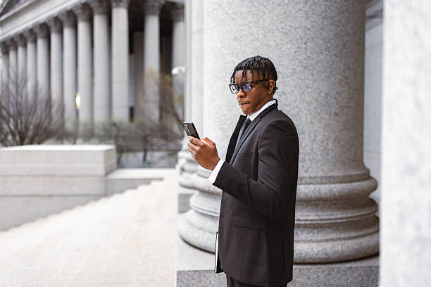 istock Professional Businessman Checking Phone near Modern Architecture 2227785058