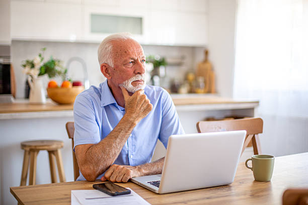 istock Senior man working from home office thinking and looking away 2227785229