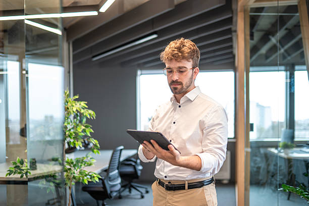 istock Professional Hispanic Businessman with Tablet in Office Space 2227785504