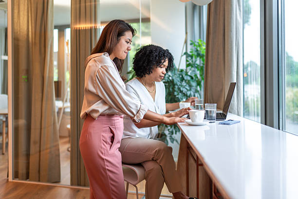 istock Diverse Businesswomen Engage in Teamwork with Technology 2227785551
