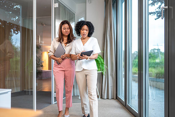 istock Diverse Businesswomen Collaborating in Office Walkway 2227785566