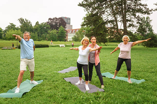 istock Senior Group Yoga Session in Park with Diverse Instructors 2227785716