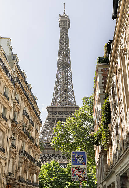 istock A back alley in Paris showcasing the architecture of Eiffel Tower view between with trees and typical parisian buildings in the foreground. 2227785788
