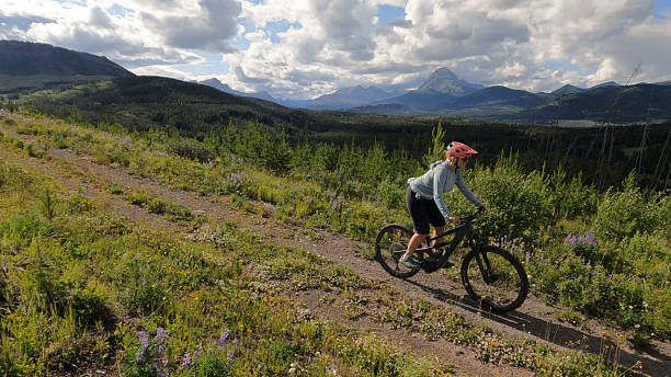 istock Mature woman rides e-bicycle on mountain track 2227786153