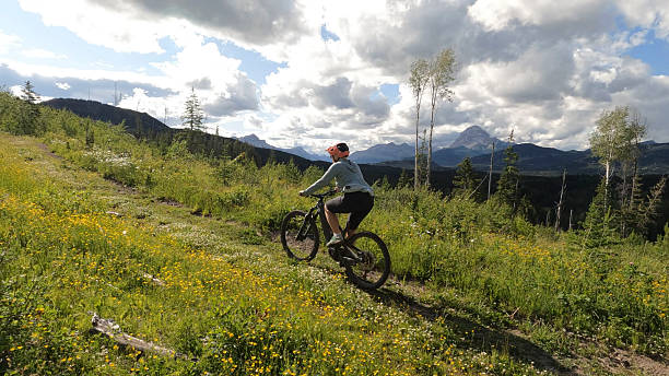 istock Mature woman rides e-bicycle on mountain track 2227786213