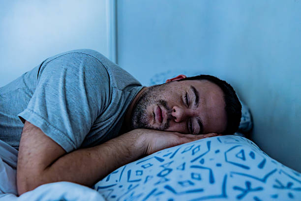 istock Young man with down syndrome resting peacefully in bed 2227786377