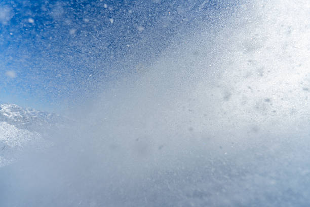 istock Dynamic Snow Spray from Skier's Sharp Turn on a Clear Mountain Day 2227788441