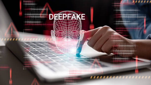 istock Concept of deepfake technology and cybersecurity risks, with facial recognition, digital identity threats, and AI-generated face manipulation warning on laptop for secure access and system safety. 2227797798