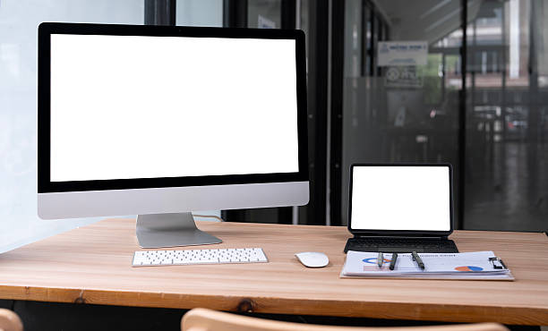 Workspace, mock up blank screen monitor desktop computer and laptop computer on wooden table in office room.