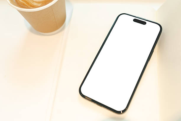 istock Hand Holding Smartphone with Blank Screen and Coffee Cup. a blank white screen, ideal for app or website mockup. technology, lifestyle, coffee culture, or mobile app presentation. 2227798927