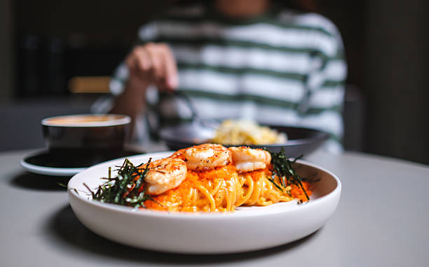 istock Closeup image of a woman eating spaghetti on dining table 2227800786