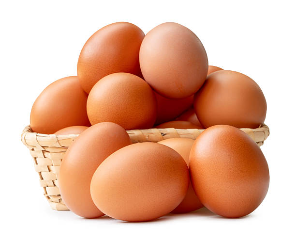istock Many brown chicken eggs in stack in wicker basket isolated on white background with clipping path 2227803525