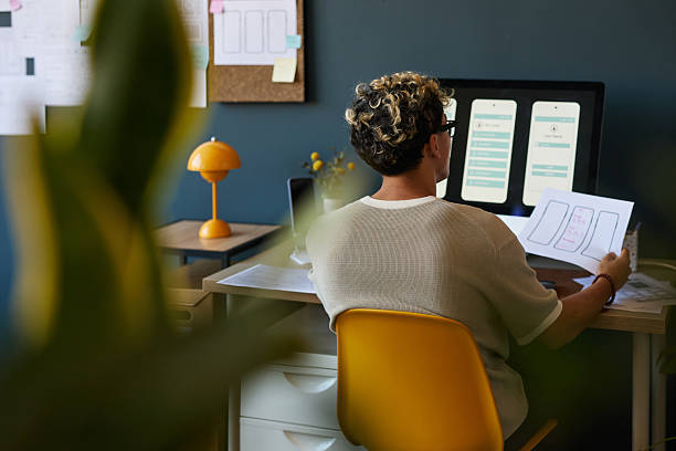 istock Young Adult Man Designing Mobile App Interface at Desk in Office 2227803532