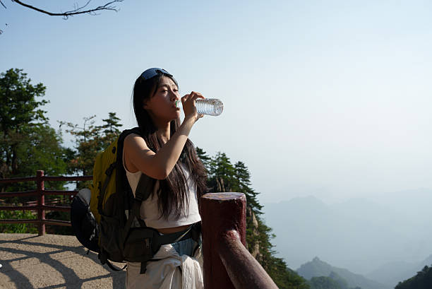 istock Hiking woman drinking water 2227808573