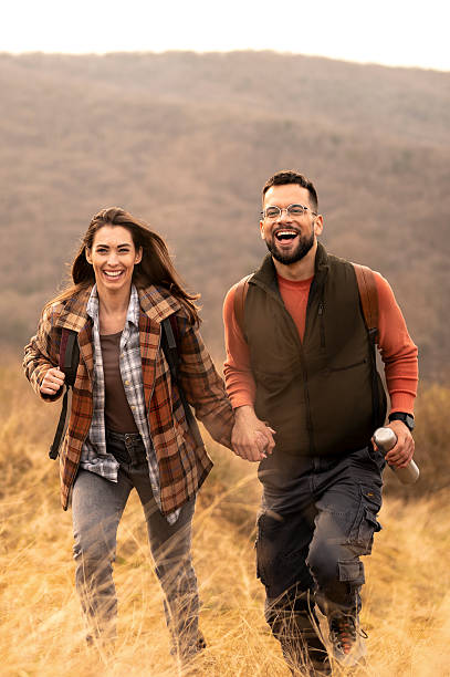 Young couple walking in nature. Both about 30 years old, Caucasian people.
