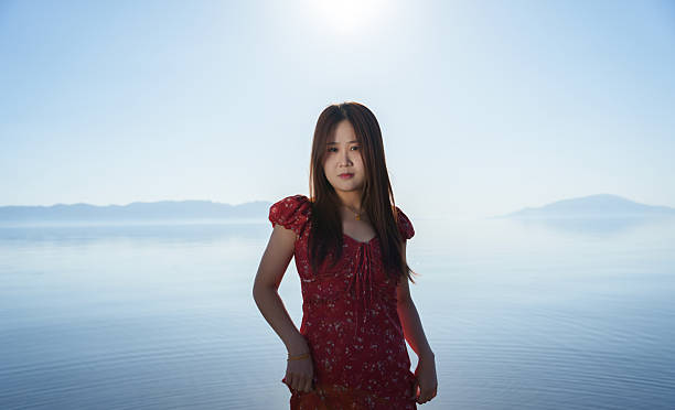 Young Asian female tourist by the water