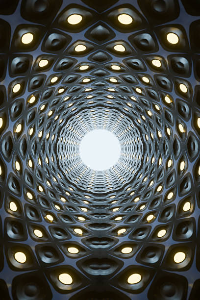 A futuristic tunnel with illuminated circular lights and a geometric pattern.