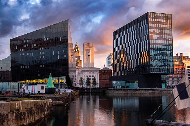 istock Modern architecture reflected in water at Liverpool waterfront at sunrise, Liverpool, Merseyside, England, Britain 2227814340